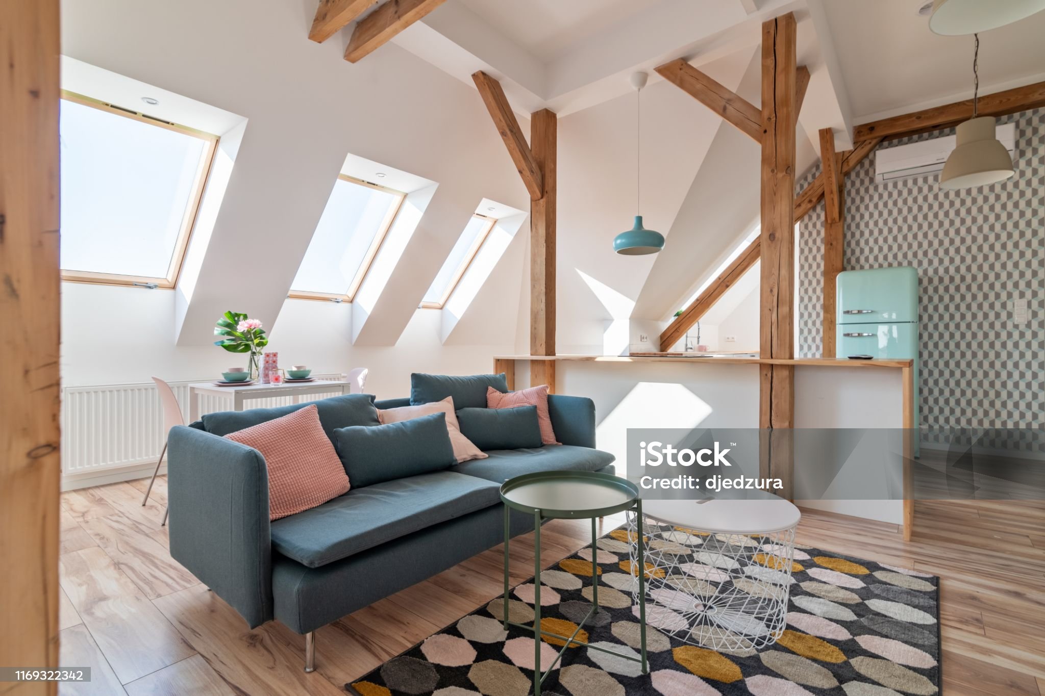 Bright attic living room with textile sofa and coffee table